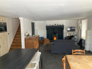 a living room with a couch and a fireplace at La Bulle du Quinze in Mazaye