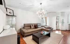 a living room with a couch and a chandelier at Lovely Apartment In Ulm With House A Panoramic View in Ulm