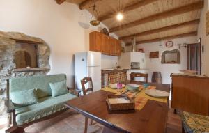 a kitchen and dining room with a table and a couch at 1 Bedroom Lovely Apartment In San Piero Patti in San Piero Patti