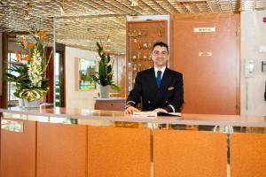 a man in a suit sitting at a desk at Bateau Seine Princess by CroisiEurope in Paris