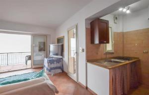 a room with a kitchen with a sink and a balcony at Amazing Apartment In Scilla With Wifi in Scilla