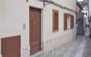 a building with brown doors on a street at Amazing Apartment In Scilla With Wifi in Scilla +7 photos