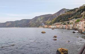 a view of a river with houses and mountains at Amazing Apartment In Scilla With Wifi in Scilla