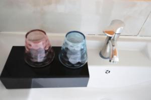 two jars sitting on a counter next to a sink at Changsha Fuxiangyuan International Hostel in Changsha