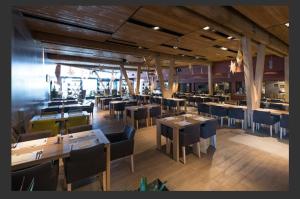 a restaurant with tables and chairs in a room at Aparthotel Vucko Jahorina NEW 451 in Jahorina