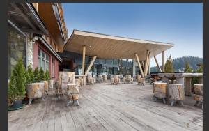 a building with tables and chairs in a courtyard at Aparthotel Vucko Jahorina NEW 451 in Jahorina