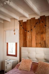 a bedroom with a bed and a wooden wall at Casa MUKAU Buenos Aires in Buenos Aires