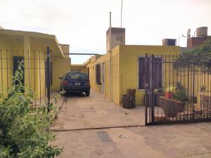 a car parked in a alley between two buildings at Lugar de descanso LA JESUSA in Playa Unión +2 photos