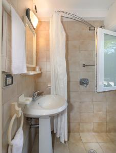 a bathroom with a sink and a shower at Storyville Simple Stay in Cinquale