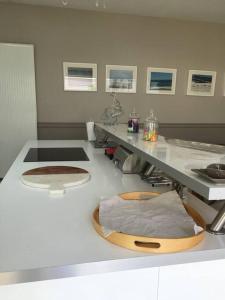 a kitchen with a counter with a cutting board on it at Deauville. Grande villa, plage. in Tourgeville