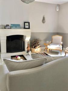 a living room with a couch and a fireplace at Deauville. Grande villa, plage. in Tourgeville