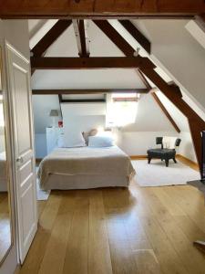 a bedroom with a large bed in a attic at Deauville. Grande villa, plage. in Tourgeville