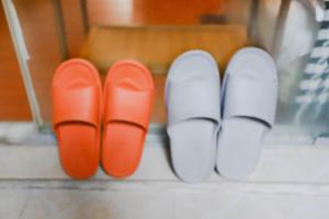a row of red and white shoes on a floor at Changsha Fuxiangyuan International Hostel in Changsha