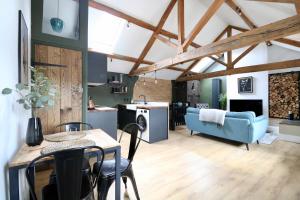 a living room with a blue couch and a table at A countryside retreat in Chipping Norton