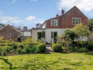 a brick house with a lawn in front of it at 3 Bed in Great Ryburgh KT143 in Great Ryburgh