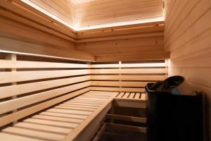 a small wooden sauna with a bench in it at Owocowe Wzgórze in Tęgoborze +36 photos