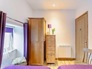 a bedroom with a wooden cabinet and a dresser at 2 bed in Barnstaple 28959 in Chapelton