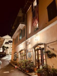 a building with a flag on the side of it at Hotel La Piazzetta in Vidiciatico