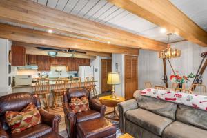 a living room with a couch and chairs and a kitchen at Chateau DuMont 05 in Aspen