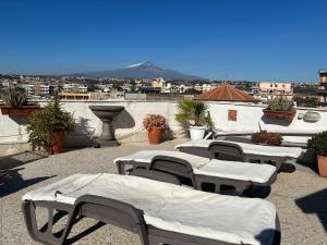 a group of tables and chairs on a roof at Residenza Parco Gioeni in Catania