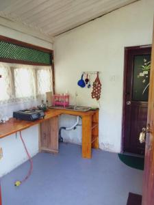 a room with a wooden desk in a room at Villa Samudra Hikkaduwa in Hikkaduwa