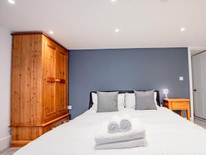 a bedroom with a large bed with two towels on it at Exquisite renovation in central location in Hereford