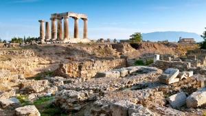 ancient ruins of a building with columns on a hill at YARD- Family retreat in Kórinthos