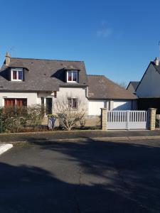 una casa con una valla blanca frente a una calle en Chez Zabou en Amboise