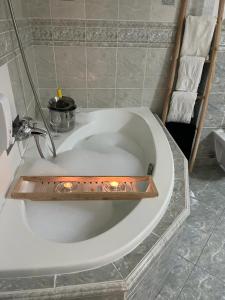 a bathroom with a bath tub with a sink at Apartments RENESANCE in Bojnice