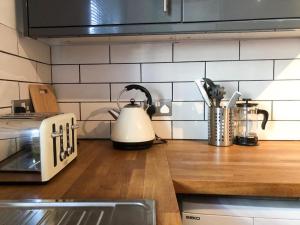 a tea kettle is sitting on a kitchen counter at Lux Home Stays - Regents Place in Leamington Spa