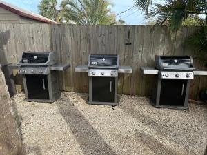 three gas bbqurgers in front of a fence at Wonder Place Wprivate Patio Next To The Beach in Cocoa Beach