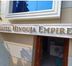 a sign for the hotel indubbula empire on a building at Hotel Hinduja Empire in Surat