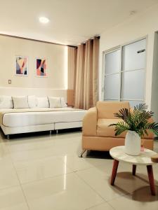 a living room with a couch and a table at Hotel Suite Center Pereira in Pereira