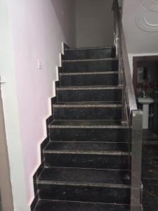 a set of stairs in a room with a stair case at Ramam hotel by Naavagat Ayodhya in Ayodhya