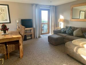 a living room with a couch and a table at Beaconsfield Farm in Wells