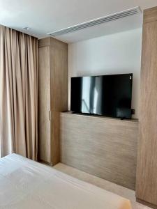 a bedroom with a flat screen tv on a wall at Stunning Studio in Business Bay in Dubai