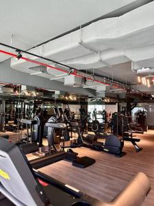 a gym with lots of treadmills and ellipticals at Stunning Studio in Business Bay in Dubai