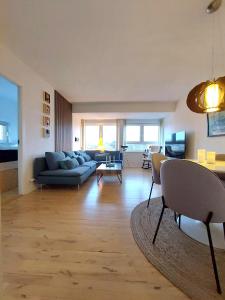 a living room with a couch and a table at Nordic style apartment in central Aalborg with a beautiful city view in Aalborg