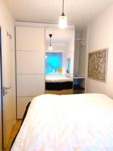 A bed or beds in a room at Nordic style apartment in central Aalborg with a beautiful city view