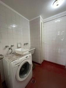 een badkamer met een wasmachine en een wastafel bij Apartamento Torre Costanera 2 Bitcoins House in Corrientes