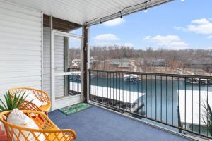 a balcony with a chair and a view of the water at Lake Ozark Vista in Lake Ozark