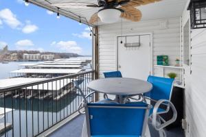 a balcony with a table and chairs and a view of the water at Lake Ozark Vista in Lake Ozark