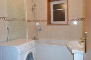 Un baño con lavadora y lavabo. en Appartement Timgad, en Gérardmer 70 fotos más