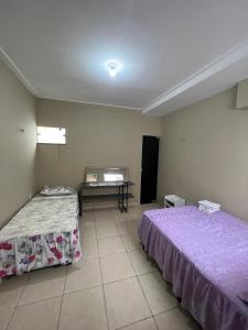Habitación con 2 camas y mesa. en Pousada da Vovó en Bragança