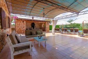 a living room with a couch and a table at Villa Sanchez in Campos +32 photos
