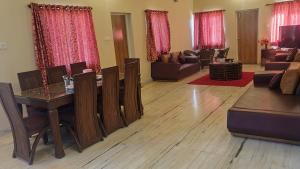 a living room with a table and a couch at Quinte Hills Residency in Panchgani