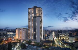 a tall building in a city at night at Savion View Apartment - Jerusalem City Center in Jerusalem