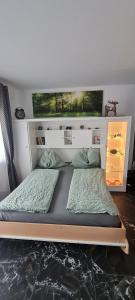 a bed in a room with two pillows at Koasablick in Ebbs +44 photos