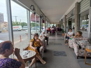 a group of people sitting in chairs in a building at Udi Hotel in Canakkale