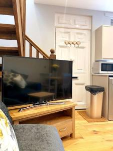 a living room with a large flat screen tv at Cosy annex in the gateway to the lakes in Burneside